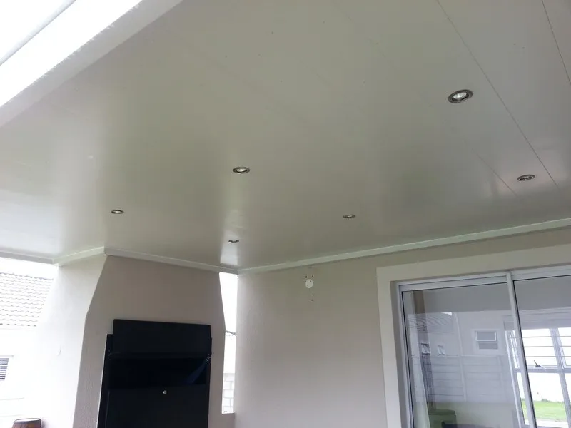 White aluminium patio ceiling with recessed downlighters over a covered patio with a built-in braai