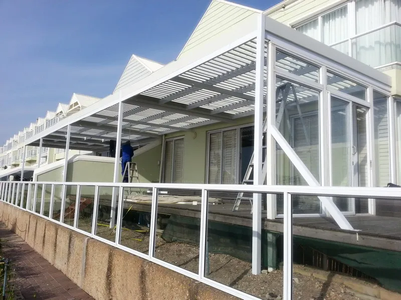 Adjustable louvre awning shading a long stoep
