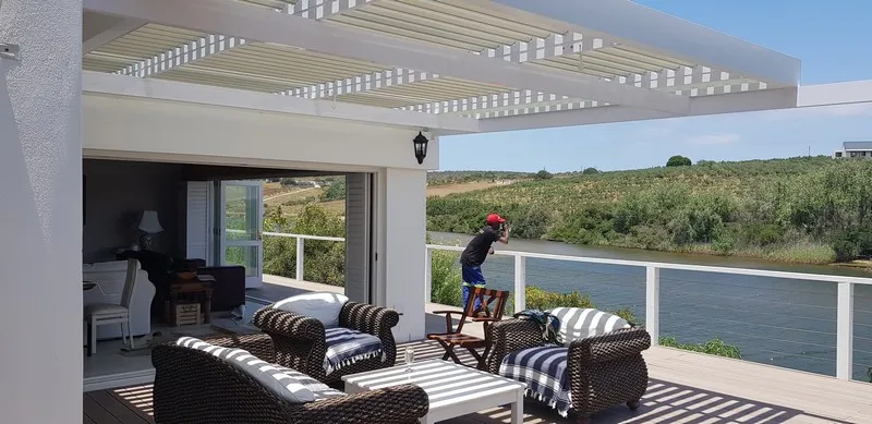 Adjustable louvre awning over a paved outdoor area