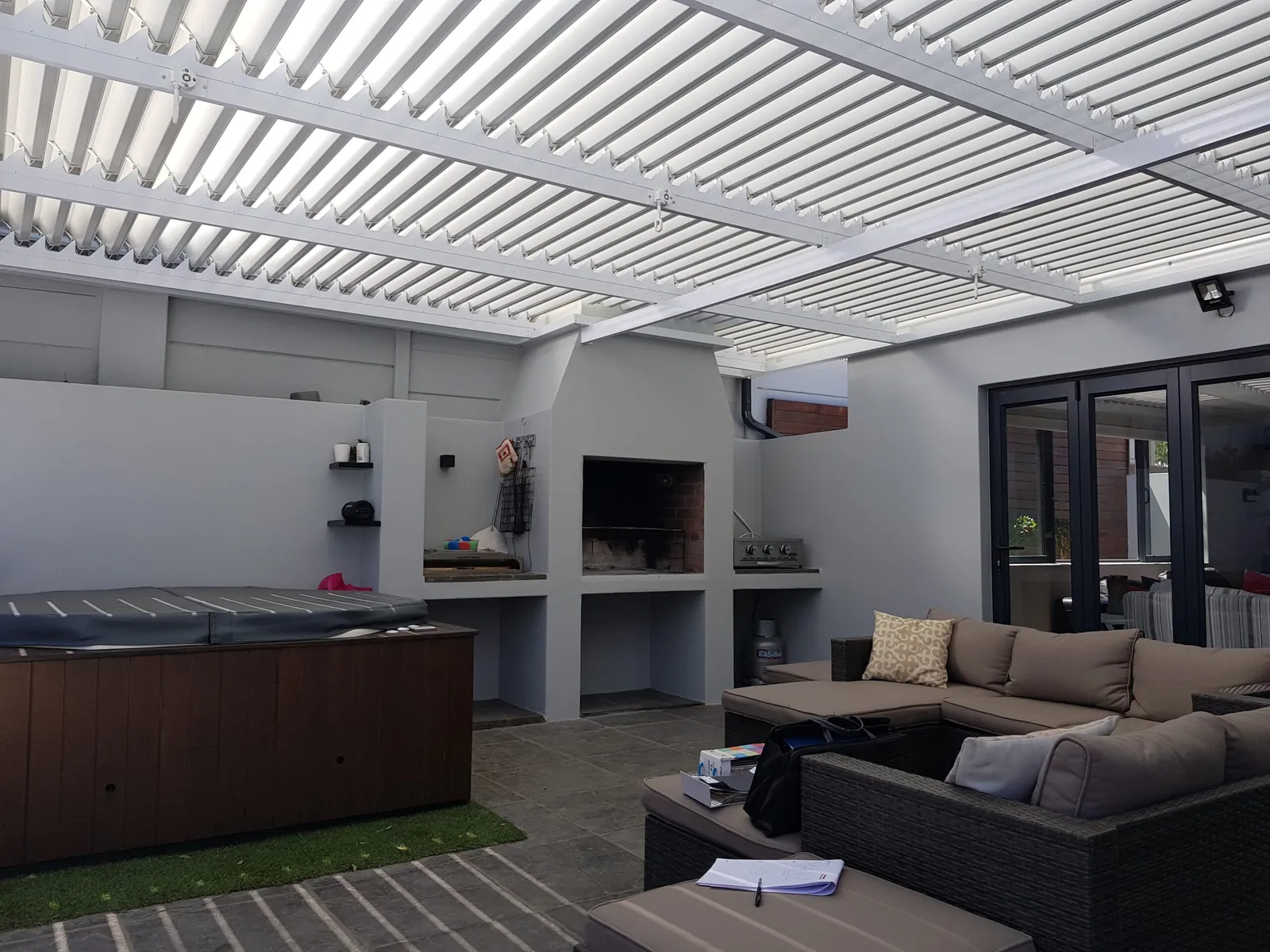 Aluminium patio roof over a green Cape Town garden