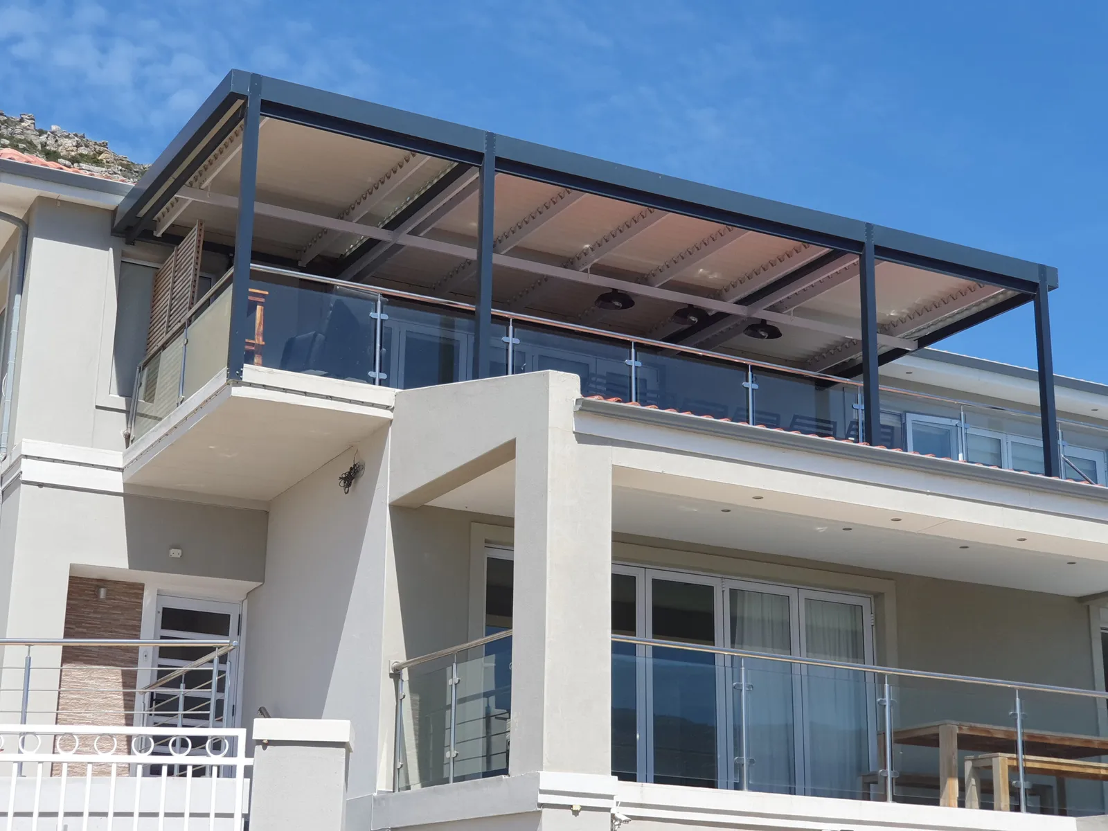 Retractable awning shading a coastal balcony