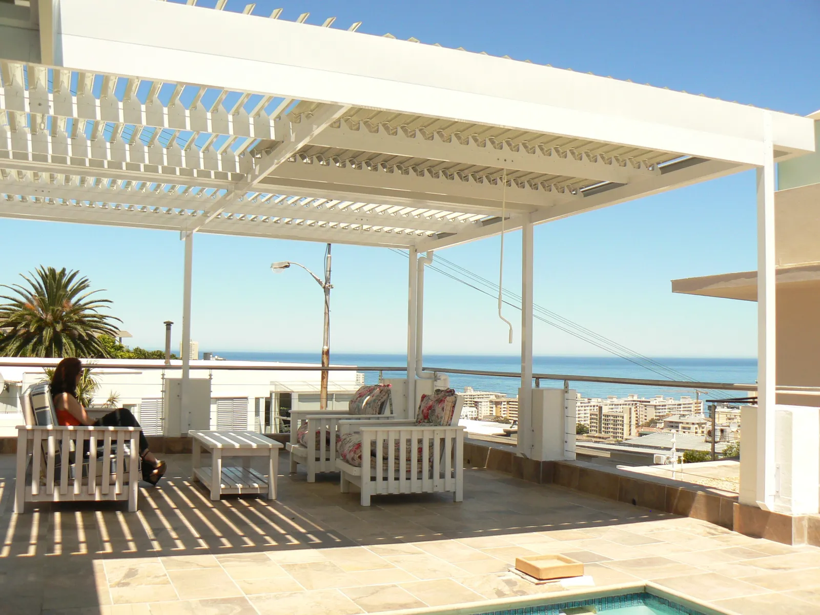 Adjustable aluminium louvre awning over a patio