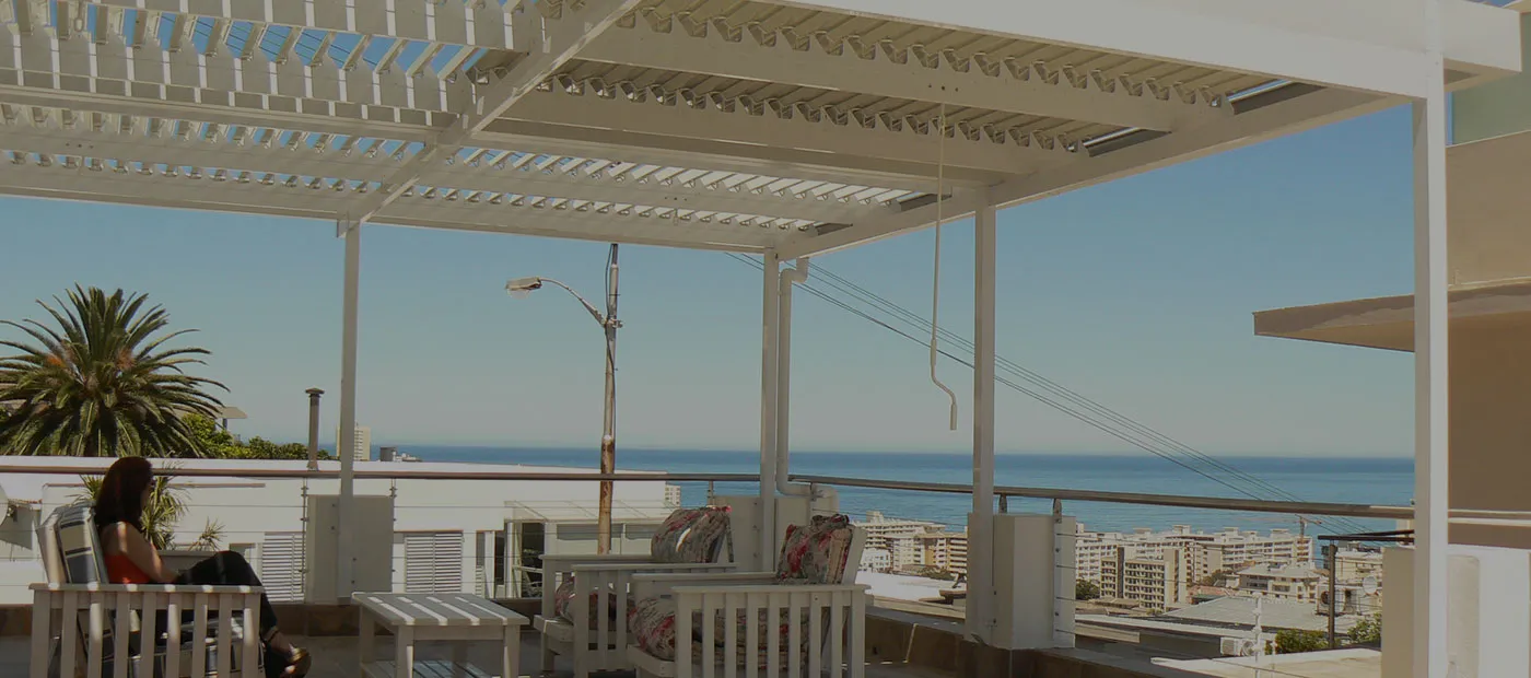 Adjustable louvre awning over an outdoor entertainment area