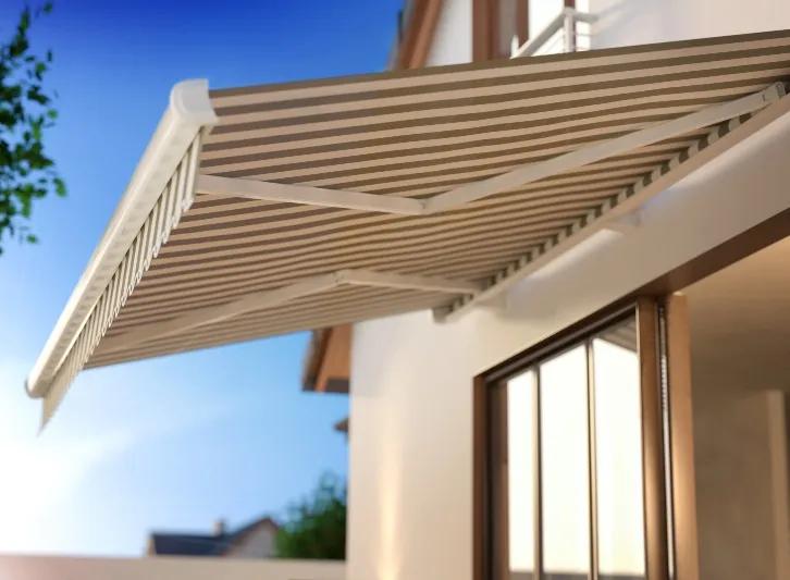 Folding arm awning extended over a window